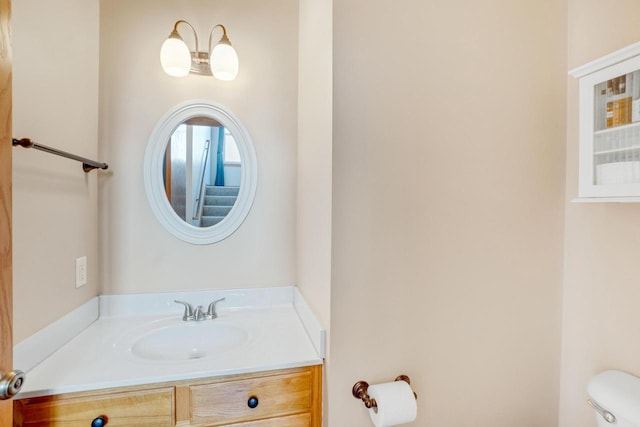 bathroom with toilet and vanity