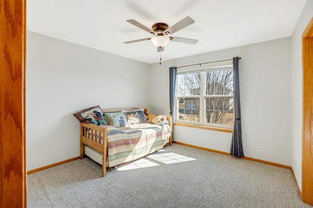 carpeted bedroom featuring a ceiling fan and baseboards