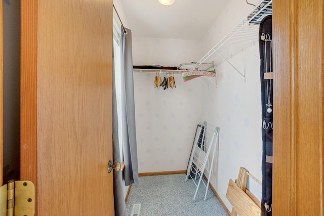 walk in closet featuring carpet flooring and visible vents