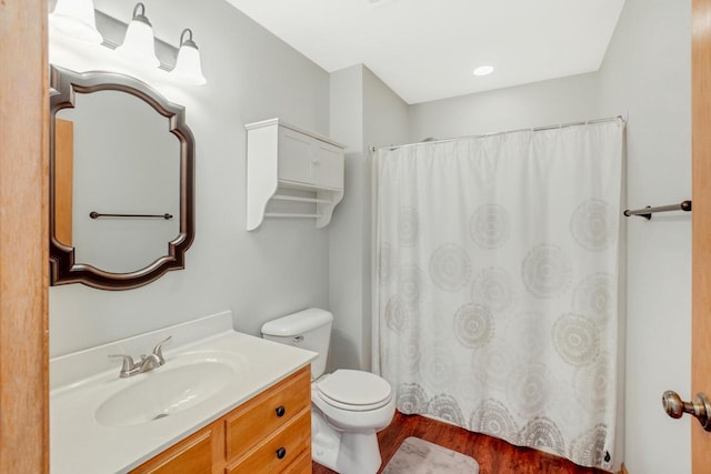 bathroom featuring vanity, a shower with shower curtain, toilet, and wood finished floors