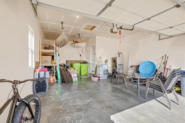 garage with a garage door opener and freestanding refrigerator