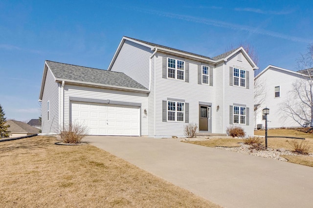 view of front of property featuring driveway, a front yard, roof with shingles, and an attached garage