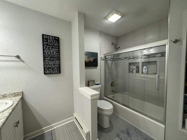 bathroom featuring baseboards, bath / shower combo with glass door, toilet, a textured wall, and vanity