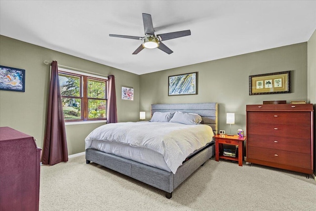 carpeted bedroom featuring baseboards and a ceiling fan