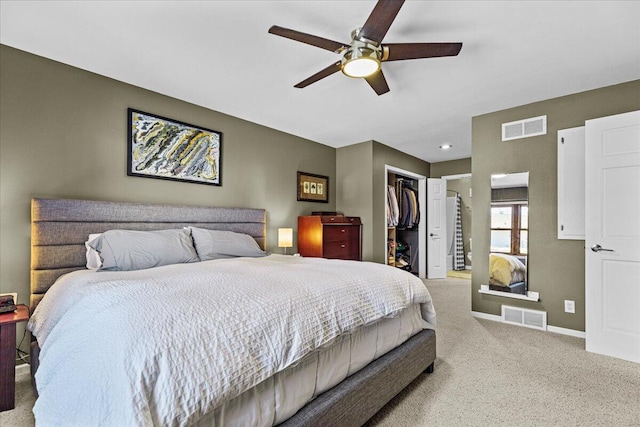 carpeted bedroom with a spacious closet, baseboards, visible vents, and a closet