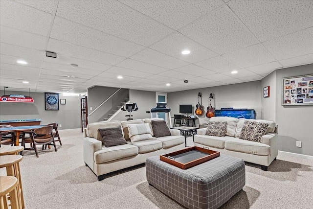 carpeted living room featuring recessed lighting, a drop ceiling, baseboards, and stairs