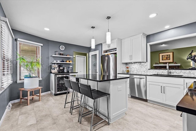 kitchen with a sink, open shelves, dark countertops, stainless steel appliances, and wine cooler