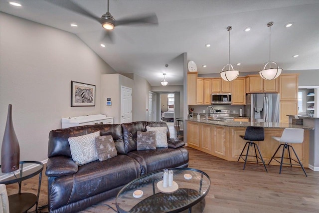 living room with recessed lighting, light wood-type flooring, lofted ceiling, and a ceiling fan