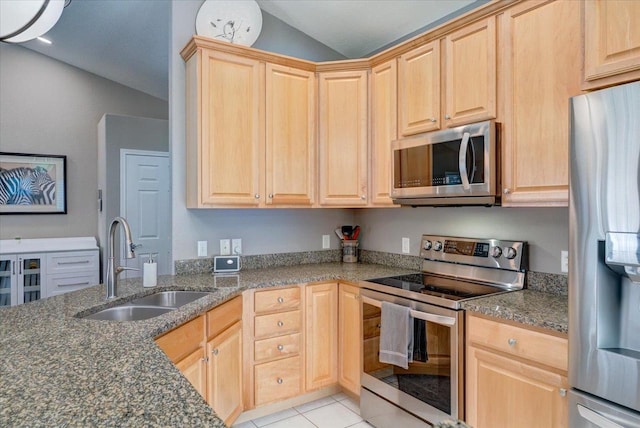 kitchen featuring a sink, appliances with stainless steel finishes, and light brown cabinets