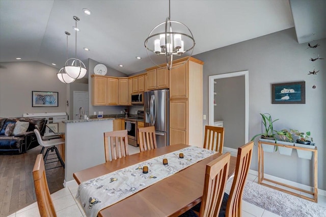 dining space with recessed lighting, an inviting chandelier, and vaulted ceiling