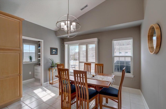 dining room with light tile patterned floors, baseboards, visible vents, lofted ceiling, and a notable chandelier