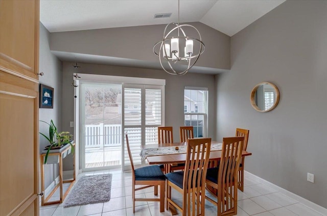 dining space featuring light tile patterned floors, baseboards, visible vents, vaulted ceiling, and a notable chandelier