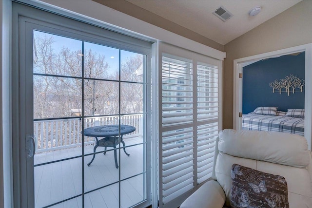 bedroom featuring lofted ceiling and visible vents