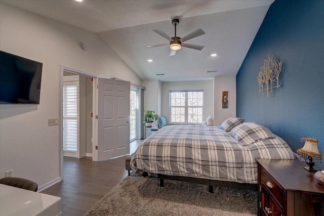 bedroom with a ceiling fan, wood finished floors, baseboards, visible vents, and lofted ceiling