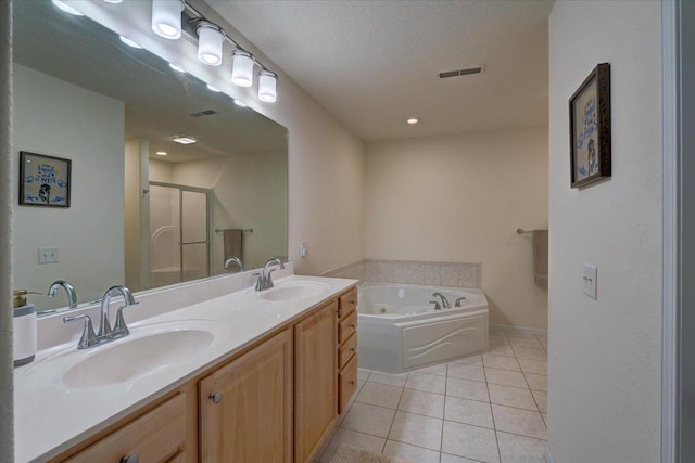 bathroom featuring a sink, visible vents, a stall shower, and tile patterned flooring