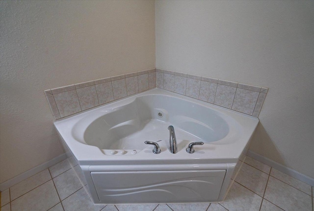 full bathroom with baseboards, a garden tub, and tile patterned flooring