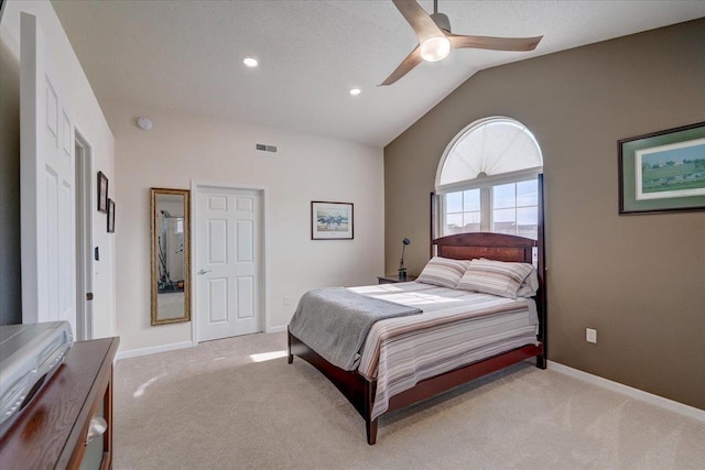 bedroom with lofted ceiling, baseboards, visible vents, and light carpet