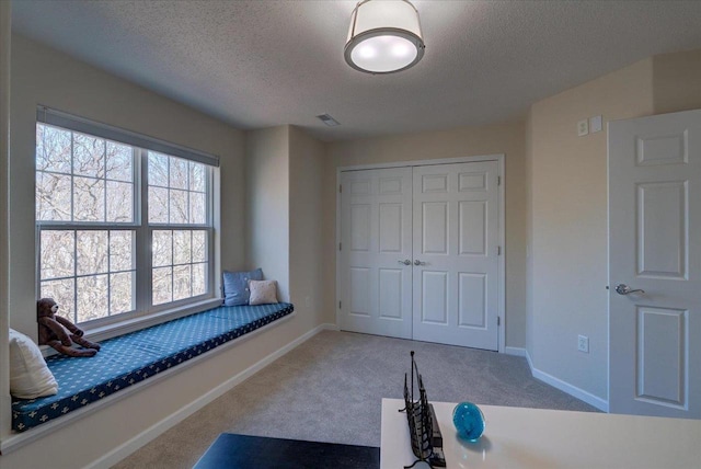 bedroom with carpet, visible vents, a closet, and baseboards