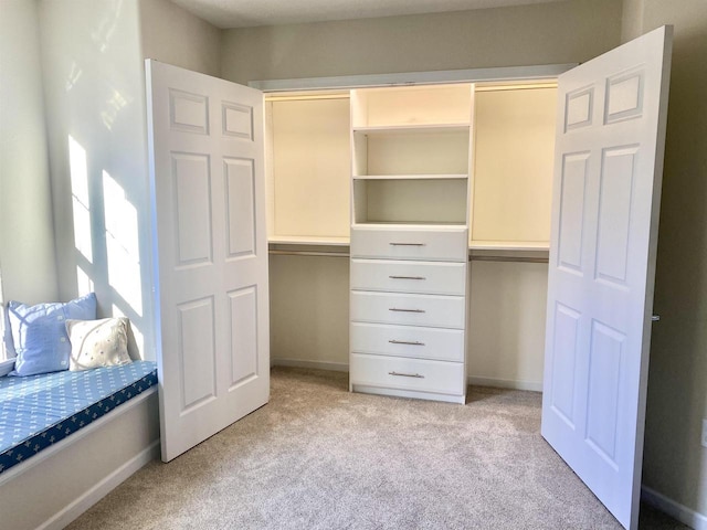 unfurnished bedroom featuring a closet, light colored carpet, and baseboards