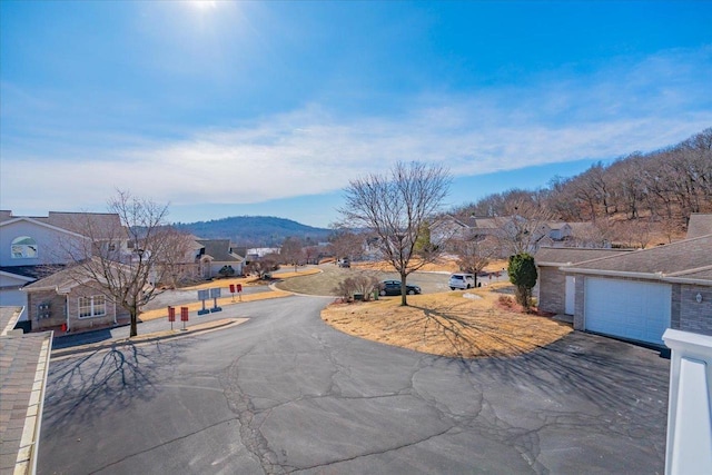 view of street with a residential view and a mountain view