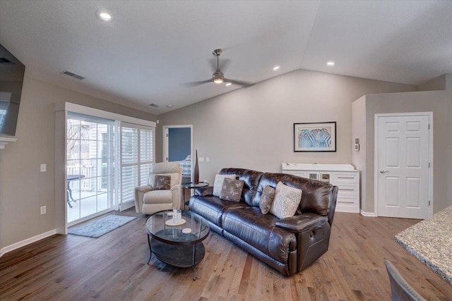 living area with visible vents, baseboards, vaulted ceiling, recessed lighting, and wood finished floors