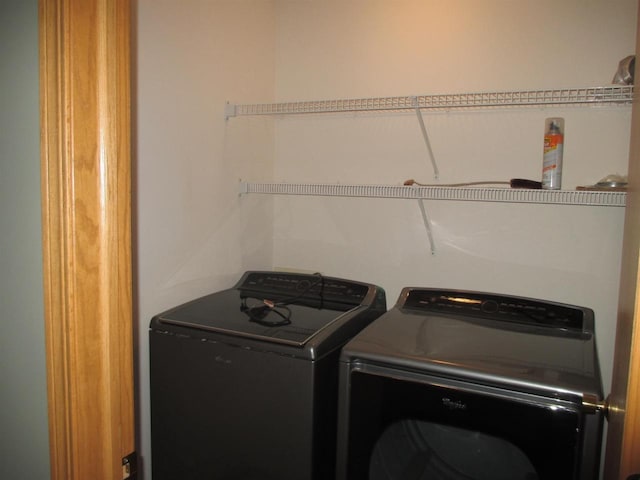 clothes washing area featuring washer and dryer and laundry area