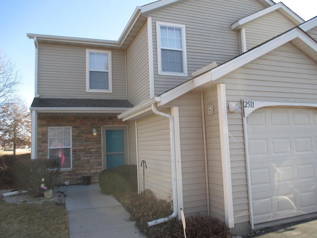 view of front of house with stone siding and a shingled roof