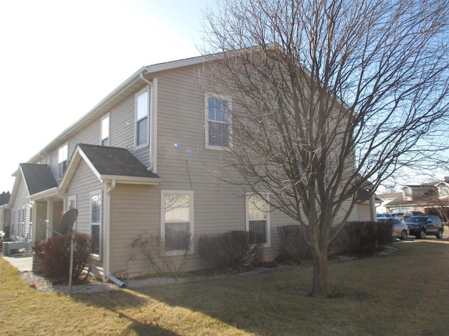 view of side of home with a yard