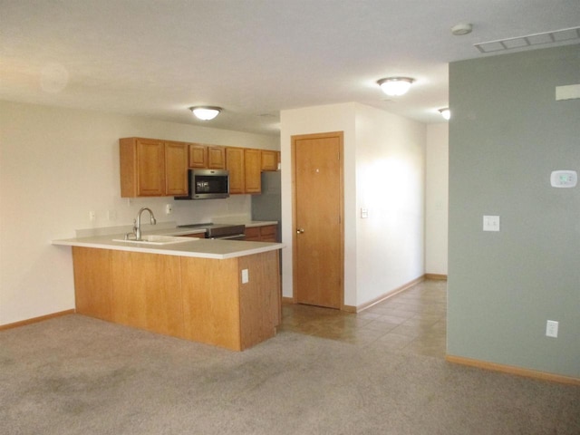 kitchen with visible vents, light colored carpet, light countertops, appliances with stainless steel finishes, and a peninsula