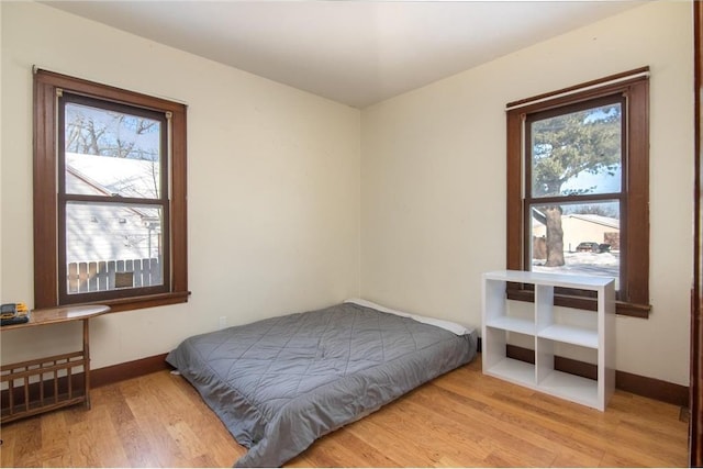 bedroom featuring wood finished floors and baseboards