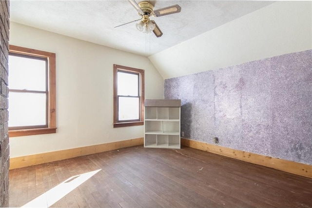 bonus room featuring baseboards, a ceiling fan, vaulted ceiling, and hardwood / wood-style flooring