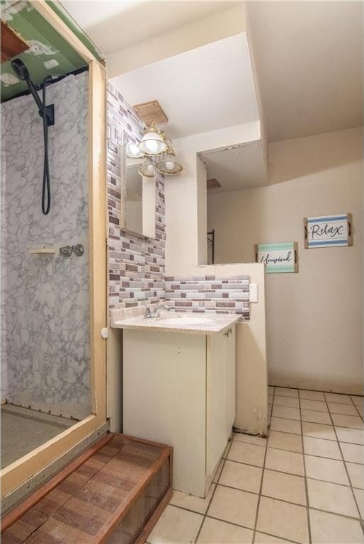 bathroom featuring decorative backsplash, a shower stall, vanity, and tile patterned flooring