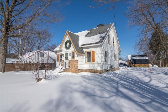 view of snowy exterior featuring fence