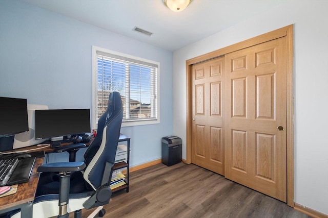 office space featuring visible vents, baseboards, and wood finished floors