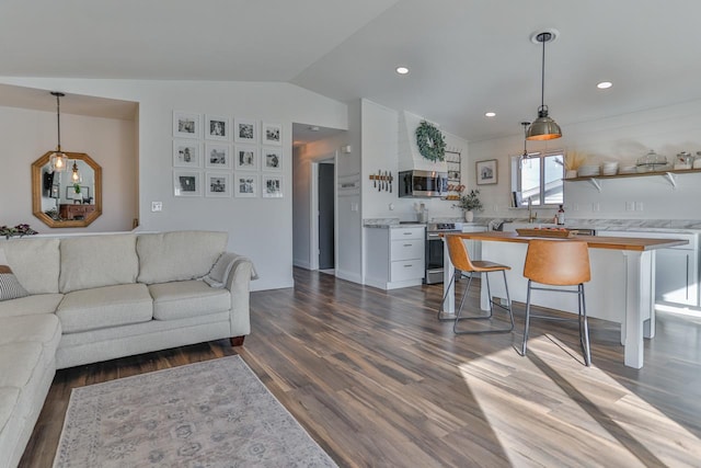 living area with dark wood-style floors, recessed lighting, and lofted ceiling