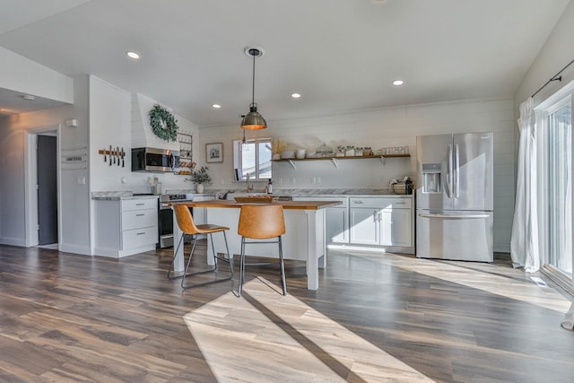 kitchen featuring wood finished floors, white cabinets, stainless steel appliances, and open shelves