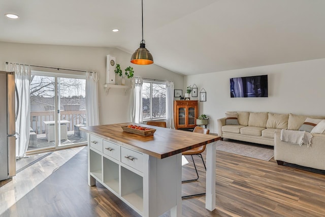 dining space featuring dark wood finished floors, recessed lighting, and lofted ceiling