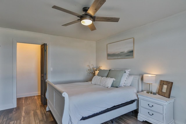 bedroom featuring baseboards, dark wood finished floors, and a ceiling fan