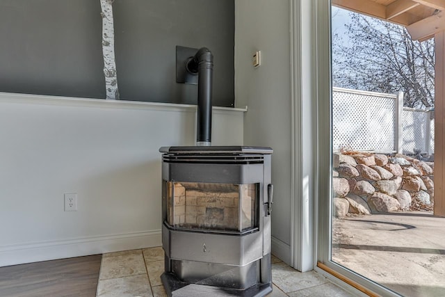 room details with a wood stove and baseboards