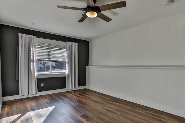 spare room featuring ceiling fan, baseboards, and wood finished floors