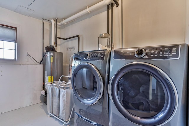 laundry room featuring laundry area, independent washer and dryer, and water heater