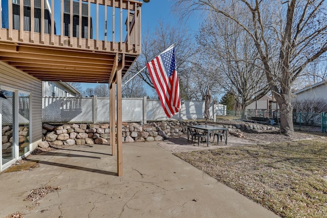 view of patio featuring outdoor dining area and fence