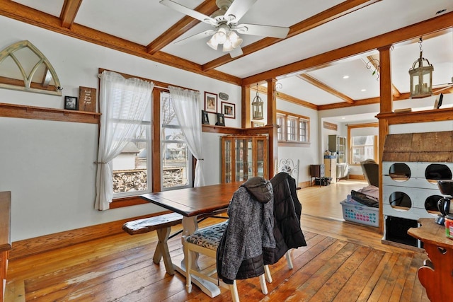 dining room featuring beam ceiling, a ceiling fan, and hardwood / wood-style flooring