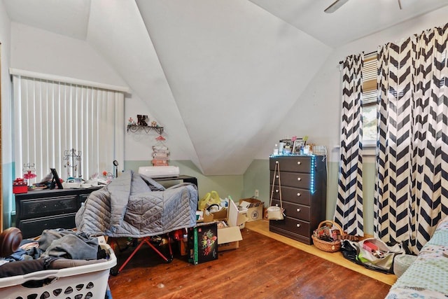 bedroom featuring lofted ceiling and wood finished floors