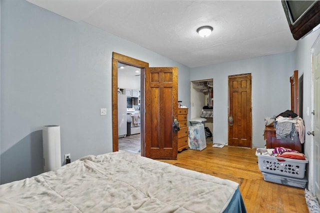 bedroom featuring a closet, a textured ceiling, and wood finished floors