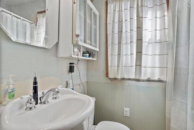 bathroom with toilet and a sink