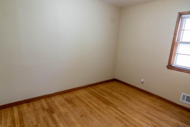 unfurnished room with visible vents, baseboards, and light wood-style floors