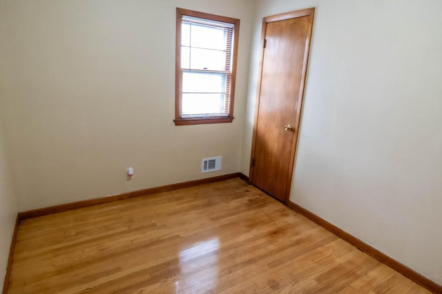 spare room with visible vents, baseboards, and light wood-style flooring