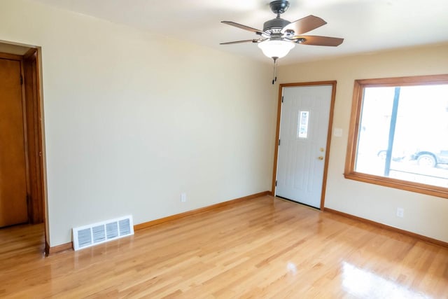 entrance foyer with visible vents, baseboards, a ceiling fan, and light wood finished floors