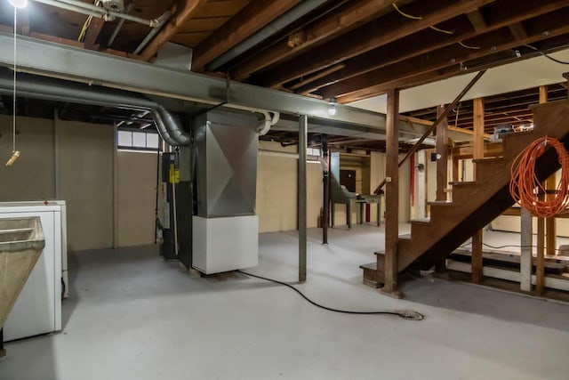 basement featuring heating unit, stairway, and washer / clothes dryer